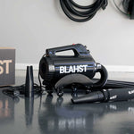 Black Blahst Air Maxx Dryer on a reflective surface with a white wall in the background