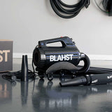 Black Blahst Air Maxx Dryer on a reflective surface with a white wall in the background
