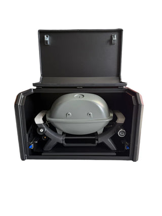 Portable grill in a black carrying case on a white background