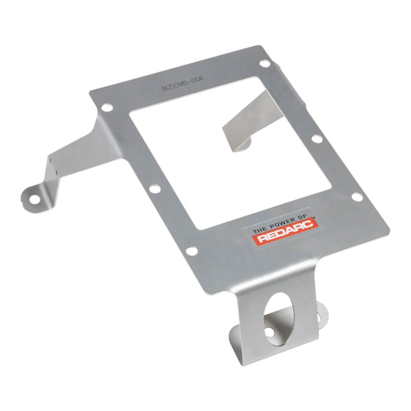 Stainless Redarc mounting bracket marked BCDCMB-006, a plate with a large rectangular cut-out, a folded retaining tang and two mounting feet, one with a large round hole