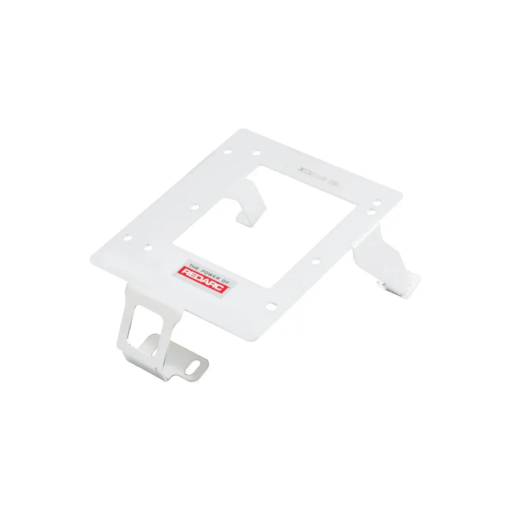 White Redarc mounting bracket at an angle, the plate with a central cut-out and two retaining tangs, with slotted feet at opposite corners
