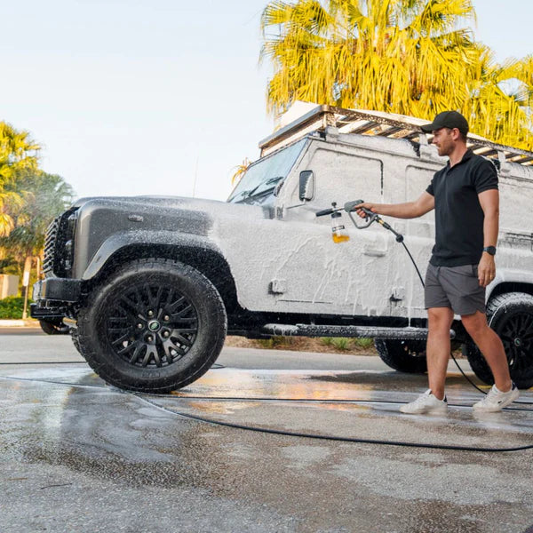 Person using the Blahst Foam Cannon on a sunny day.