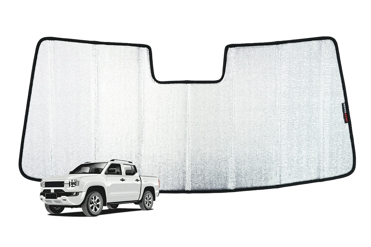 Reflective silver face of the SnapShades sun shade laid flat, cut to the BYD Shark windscreen shape with a rear-view mirror notch
