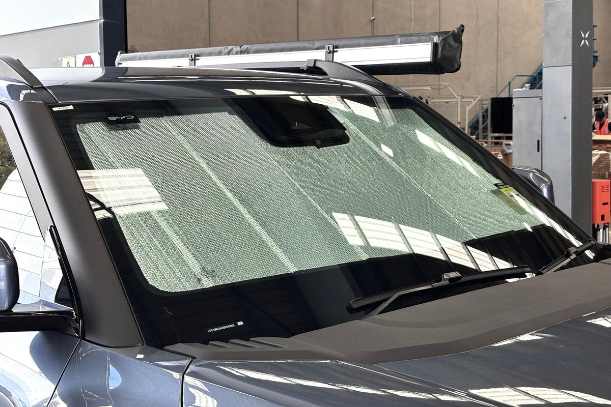 BYD Shark seen from outside with the sun shade in place behind the windscreen, reaching the full width of the glass