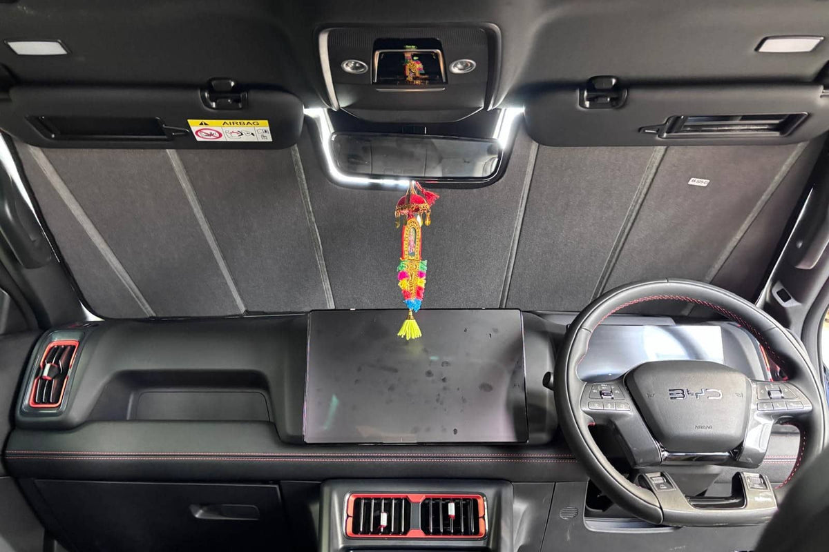 Sun shade fitted inside a BYD Shark, covering the full windscreen from the dashboard to the headlining with the mirror sitting clear