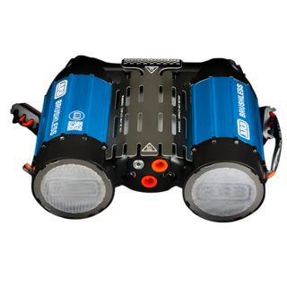 ARB brushless twin compressor seen from the front, two blue anodised cylinders either side of a black vented heatsink, the mesh-covered intake filters on the ends and the orange fittings and outlet ports across the centre