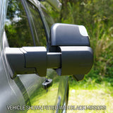Close-up of a vehicle with black side mirrors against a natural background