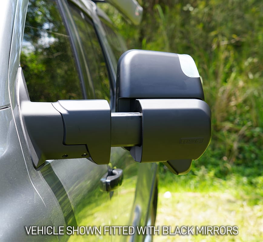 Close-up of a vehicle with black side mirrors against a natural background