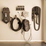 Wall-mounted automotive tools and equipment including a pressure washer, hoses, and nozzles.
