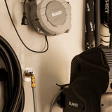 Blast brand extension cord reel and tools mounted on a wall.
