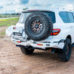 White SUV with spare tire mounted on a dirt road