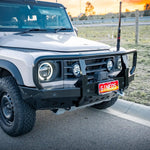 White off-road vehicle with a sunset in the background