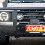 Front view of a vehicle with a license plate reading 'GINEos Australia' on a blurred background.
