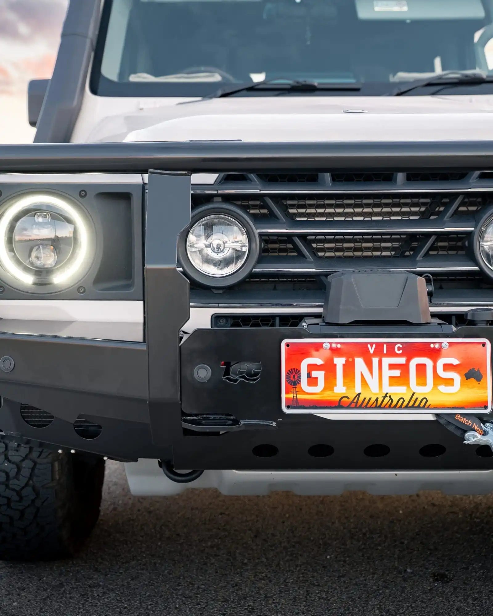 Front view of a vehicle with a license plate reading 'GINEos Australia' on a blurred background.