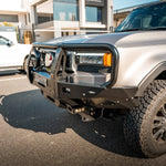 Silver SUV with a front bumper in an urban setting