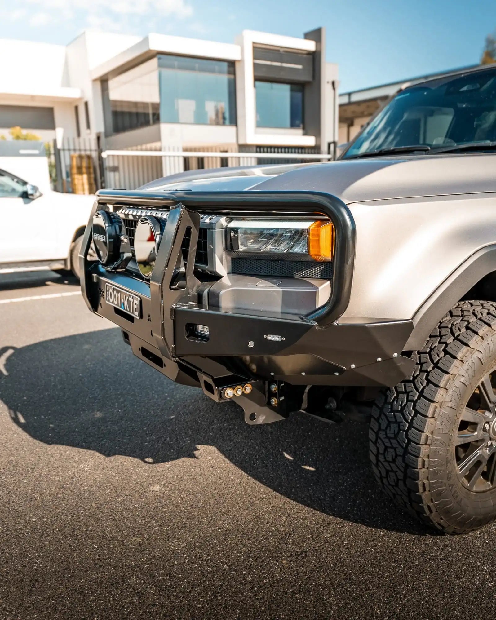 Silver SUV with a front bumper in an urban setting