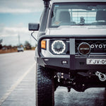 White off-road vehicle with custom modifications on a road