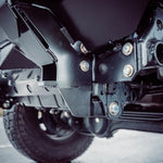 Close-up of a black LC70 suspension system on a road.