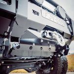 Close-up of a vehicle's front bumper with TCC branding and license plate.