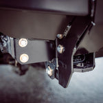 Close-up of a metal bracket with screws on a dark background