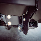 Close-up of a metal bracket with screws on a dark background