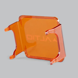 Amber DX4 lens cover from the rear quarter, the clips and side skirts in front of the panel with the ALTIQ name showing through from behind