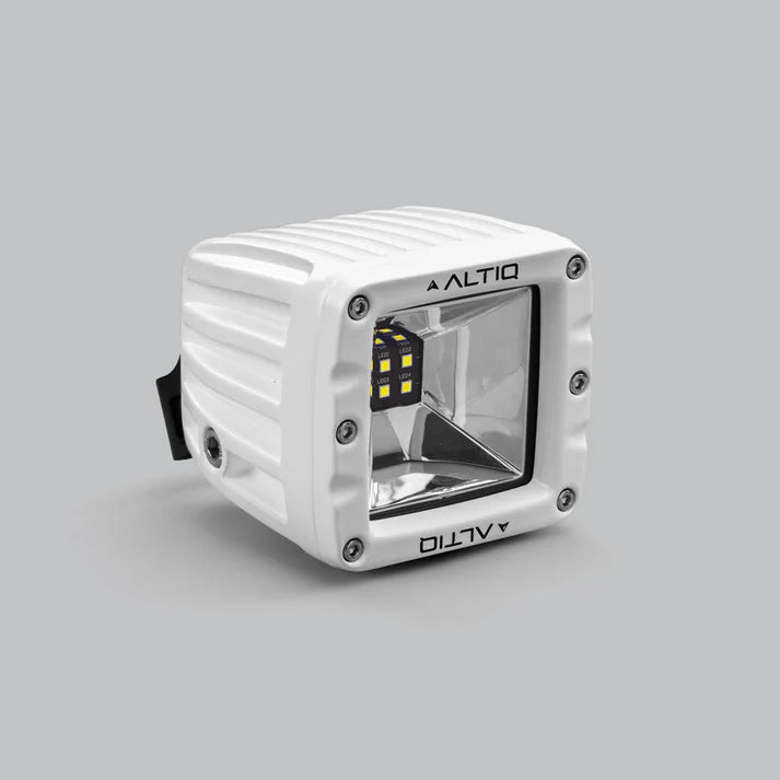 White DX4 Scene work light at a three-quarter angle, the ALTIQ name on the bezel with the reflector and LED cluster angled toward the camera