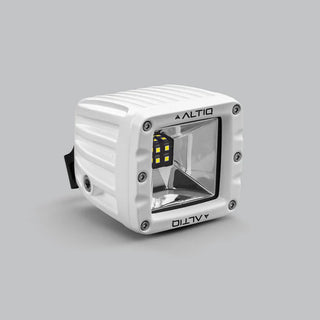 White DX4 Scene work light at a three-quarter angle, the ALTIQ name on the bezel with the reflector and LED cluster angled toward the camera