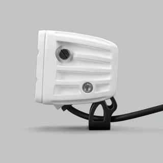 White DX4 Scene work light in profile from the rear, the ribbed white housing with two adjustment screws and the black bracket beneath carrying the lead