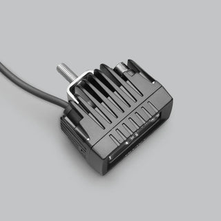 ALTIQ CX2 work light from above and behind, showing the finned cast heatsink, the threaded mounting stud and the cable leaving the rear