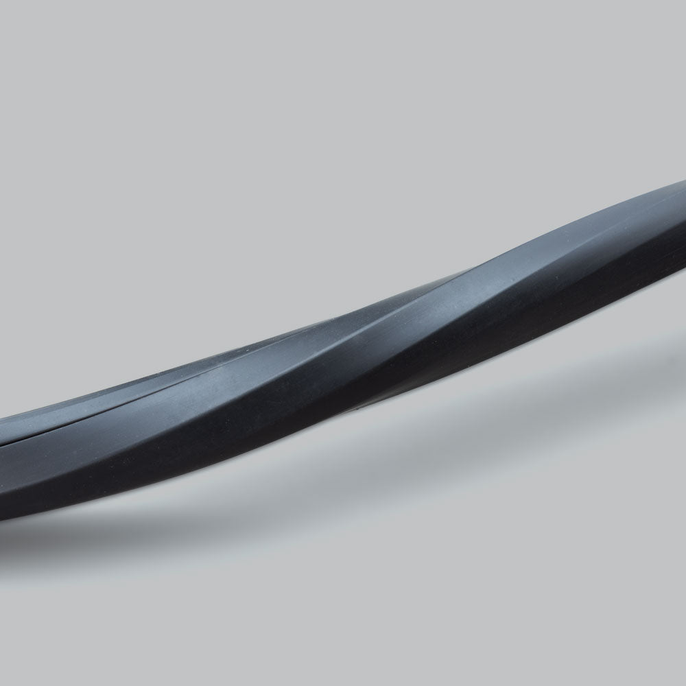 A length of the black wire concealer curved across the frame, showing how the flexible moulding follows a bend