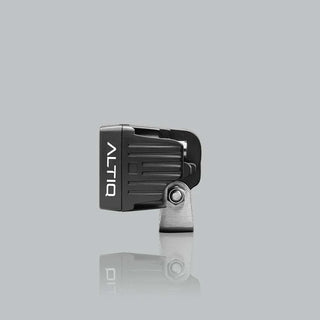 ALTIQ CX2 work light seen from the side, the ribbed black housing with the ALTIQ name down the face and the stainless mounting bracket and bolt below