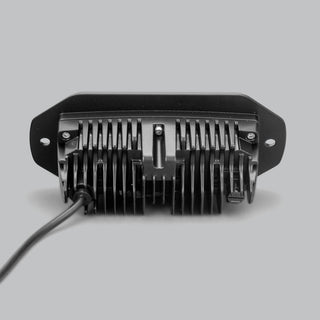 The CX4 flush mount seen square on from behind, the finned heatsink centred in the flange with a fixing hole at each end and the lead running out to one side