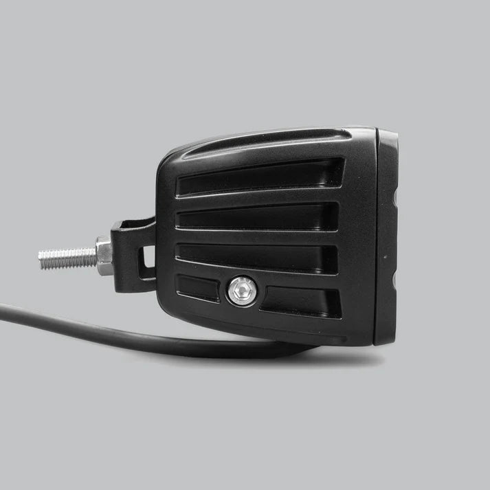 DX4 work light side on, the ribbed housing profile with the mounting bracket bolted through the flank and the cable running forward