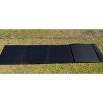 Black solar panel on grass