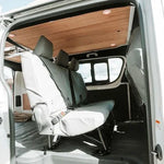 Van interior with white seats and wooden ceiling