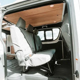Van interior with white seats and wooden ceiling