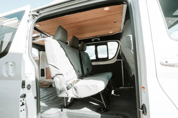 Van interior with white seats and wooden ceiling