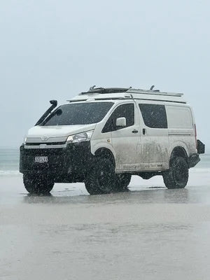 White van on a rainy landscape