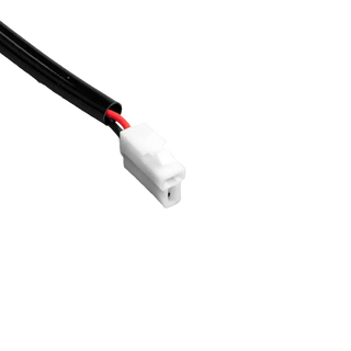 Close-up of the white two-pin plug on the halogen piggy-back adaptor, red and black wires entering the moulded body from the black sheathed lead