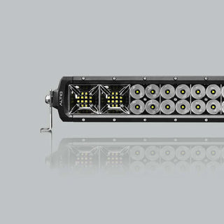 The double row bar seen along its length, the flood section at the near end giving way to two rows of round spot optics, with a stainless foot at the end