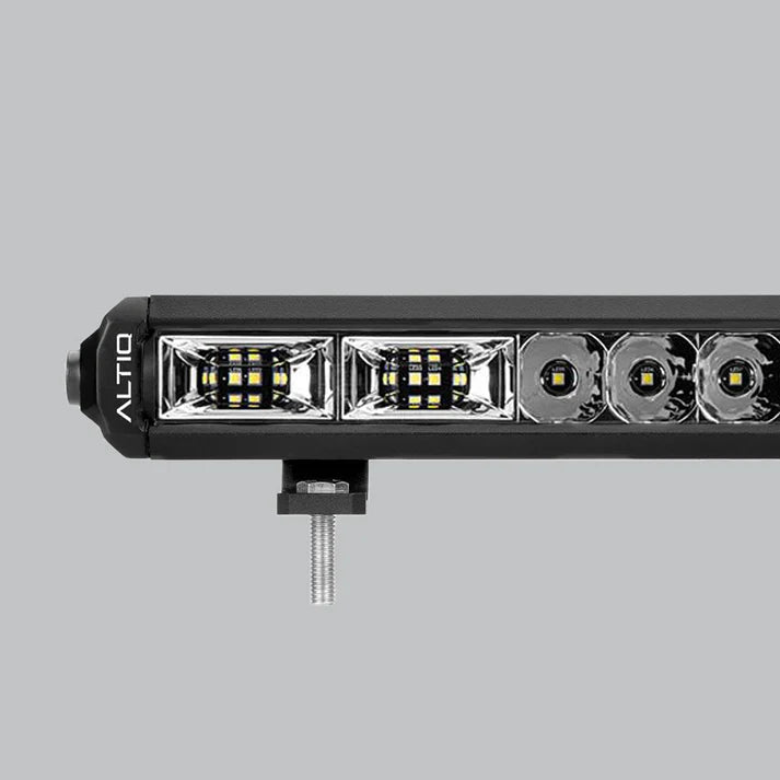 Close-up of the hybrid light bar's optics, showing two rectangular flood reflectors with dense LED clusters at the end nearest the ALTIQ-marked cap, then round spot reflectors running away down the bar