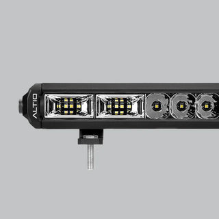 Close-up of the hybrid light bar's optics, showing two rectangular flood reflectors with dense LED clusters at the end nearest the ALTIQ-marked cap, then round spot reflectors running away down the bar
