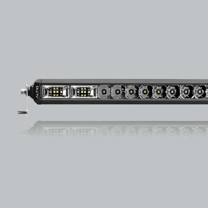 The hybrid light bar seen along its length, the flood section at the near end giving way to a run of round spot optics, with a mounting foot at the end