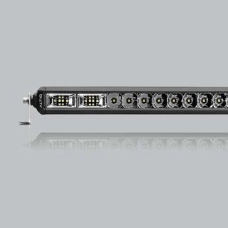 The hybrid light bar seen along its length, the flood section at the near end giving way to a run of round spot optics, with a mounting foot at the end