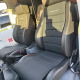 Car interior with folded seat showing brand logo