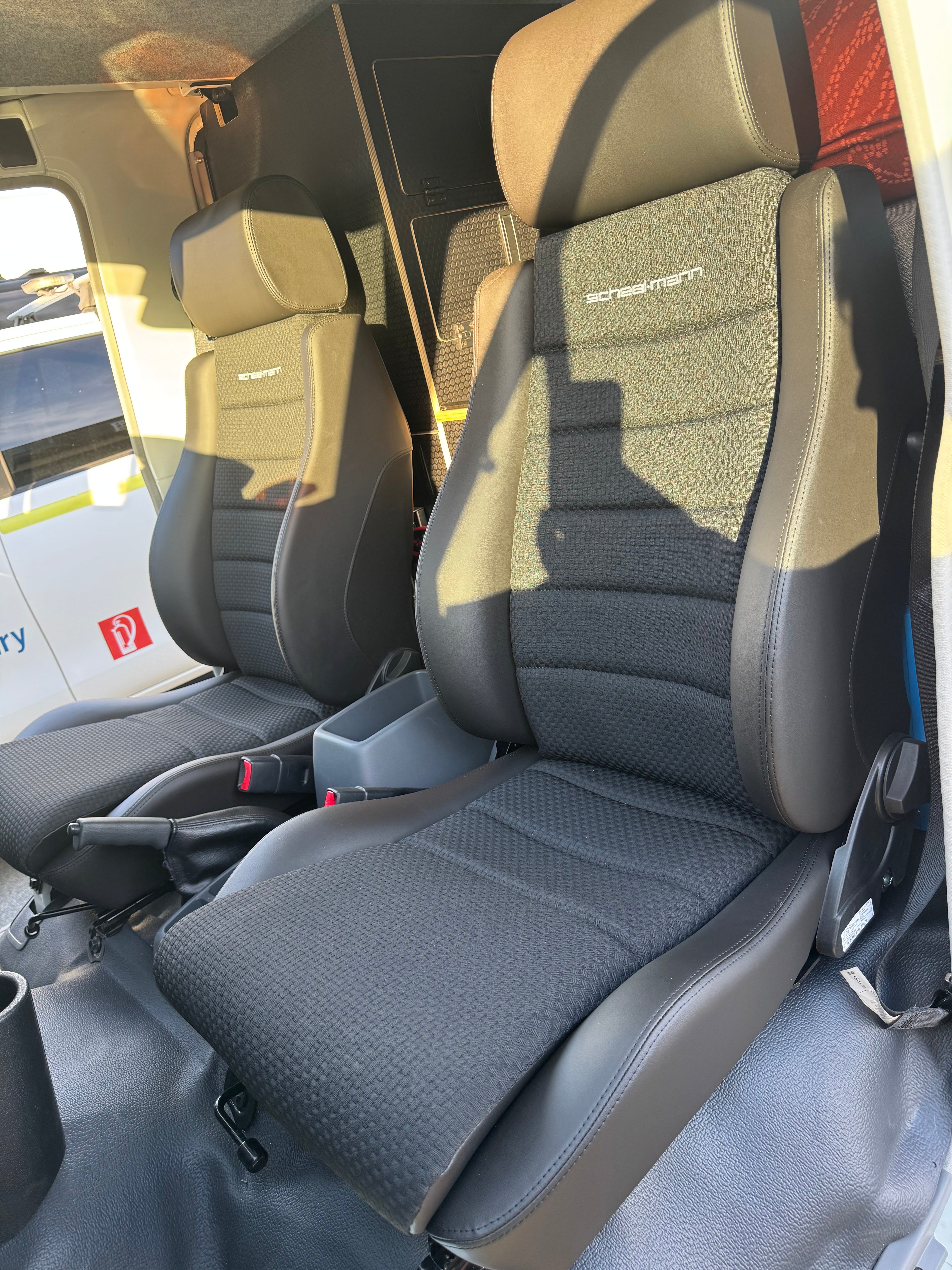 Car interior with folded seat showing brand logo