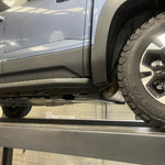 Car on a lift in a garage setting