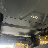 Close-up of a vehicle's undercarriage with a metal guard