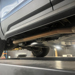 Close-up of a vehicle on a lift in a garage setting